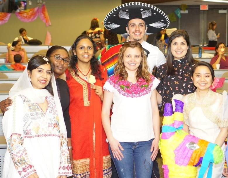 International residents dressed in clothing representative of their cultures.